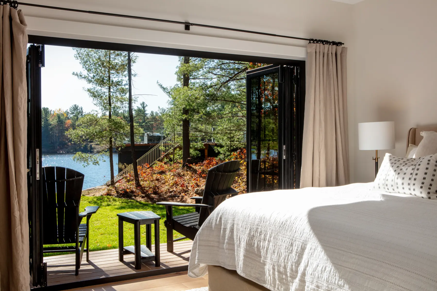 Traditional Lakeside Cottage Lakeside Escape Project Portfolio Interior Primary Bedroom Folding Doors Private Deck Normerica Timber Homes