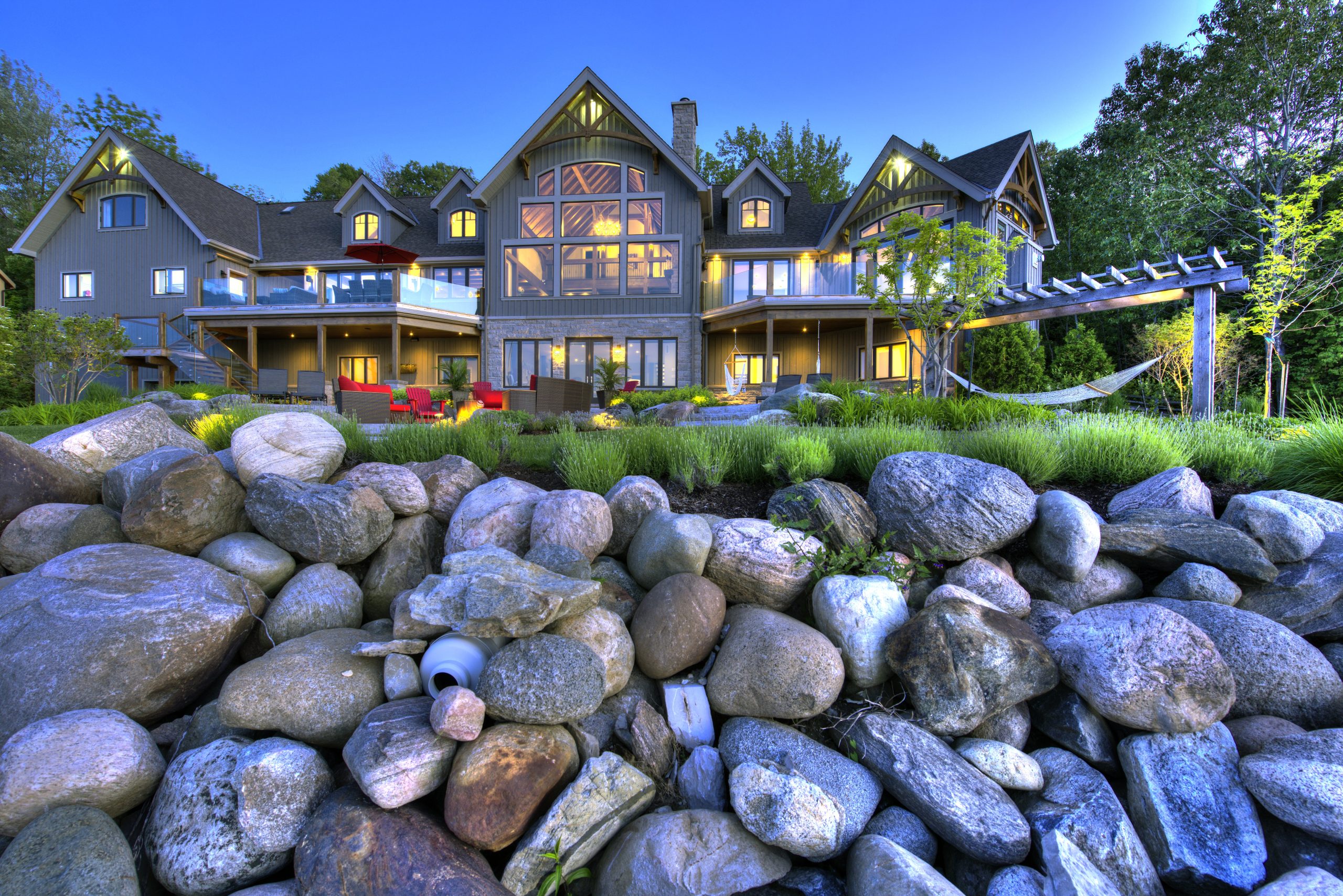 perfect harmony custom timber frame waterfront residence exterior rocks